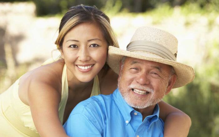 Senior Man With Adult Daughter In Garden