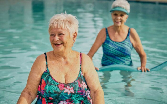 Two retirees relaxing poolside